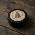 Black container with a label on a wooden surface