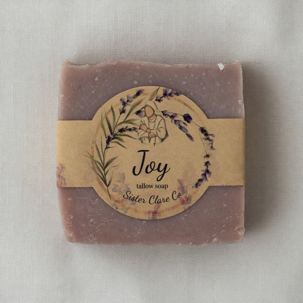 Bar of soap with a decorative label on a light fabric background