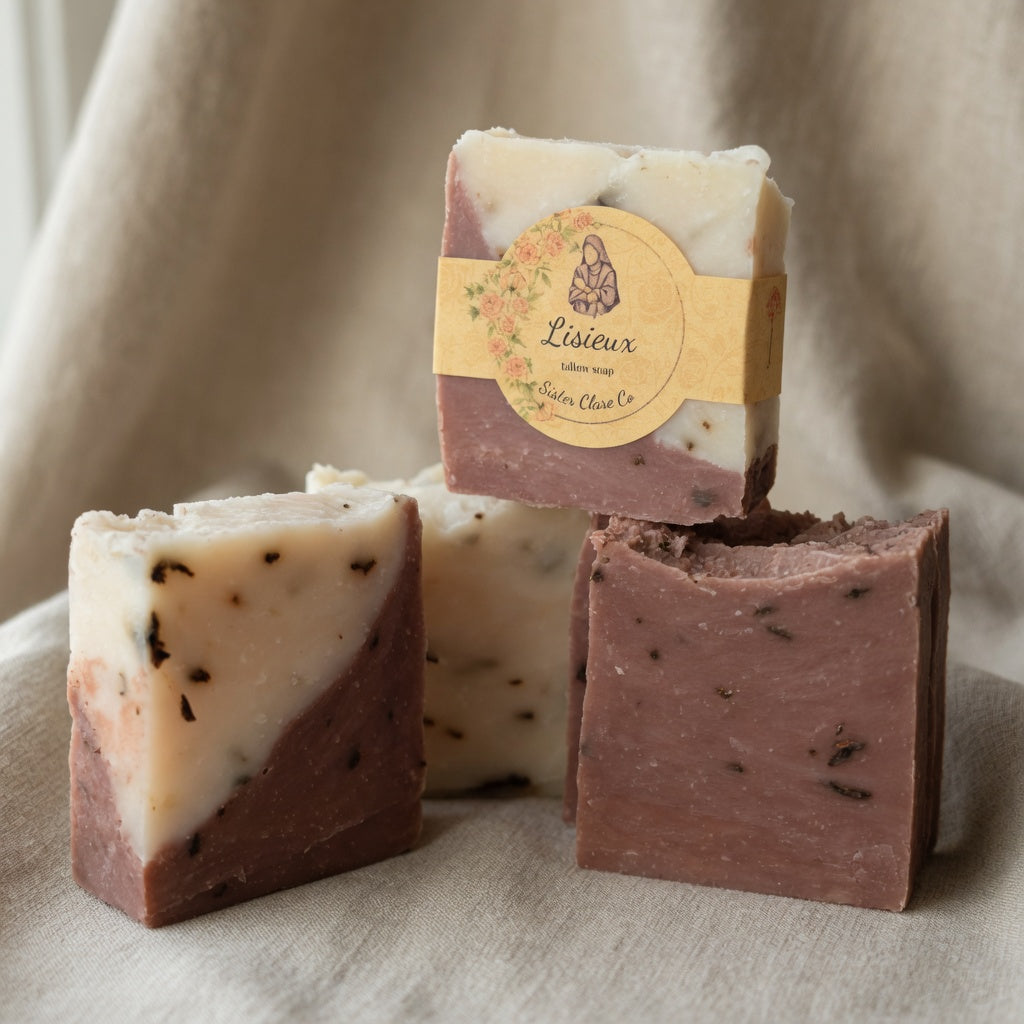 Close-up of LISIEUX tallow soap texture showing detailed red and white marbling and natural botanicals on soft linen background