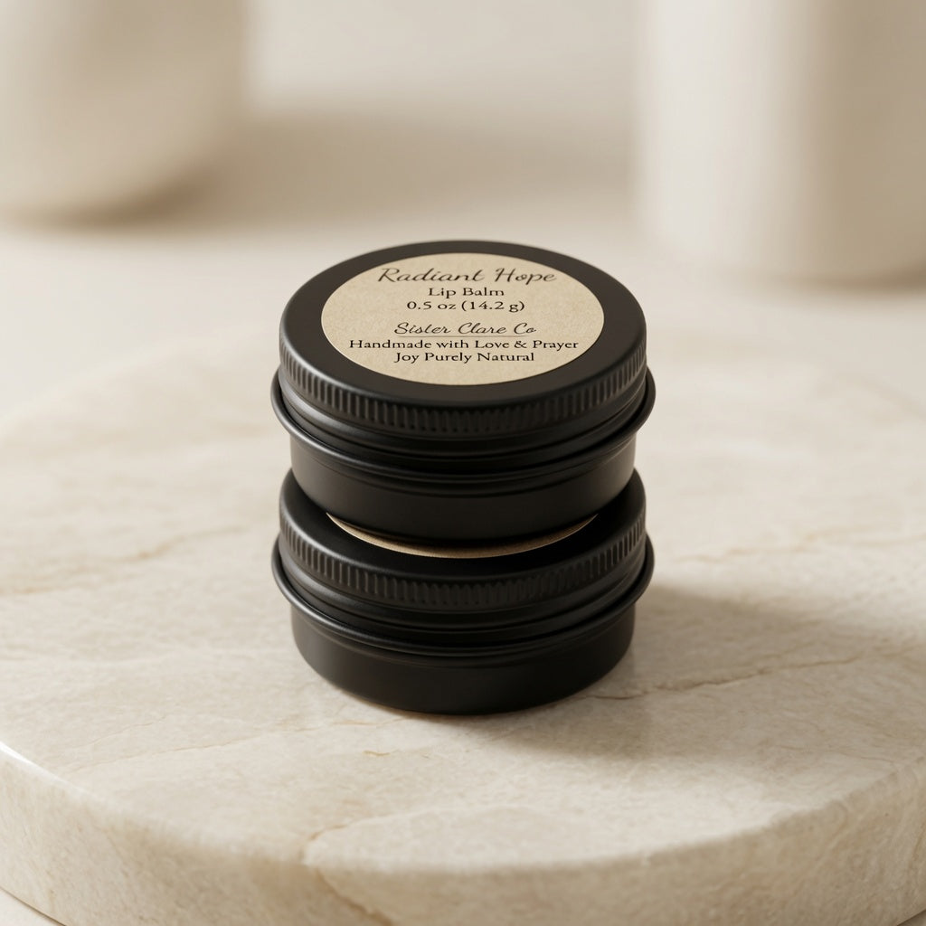 A stack of three round black metal lip balm tins sits on a light beige marble surface. The top tin is open, showing a beige balm inside, and the top of the stacked tins features a beige circular label that reads 'Radiant Hope Lip Balm' and 'Side's Olive Co'.