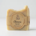 A single bar of pale beige tallow soap wrapped in a kraft paper band with a round label reading 'Clemens' and 'Sister Clare Co', photographed on a clean white background.