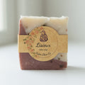 Single LISIEUX tallow soap bar on clean white background, minimalist product shot emphasizing the red and white rose marbling and label