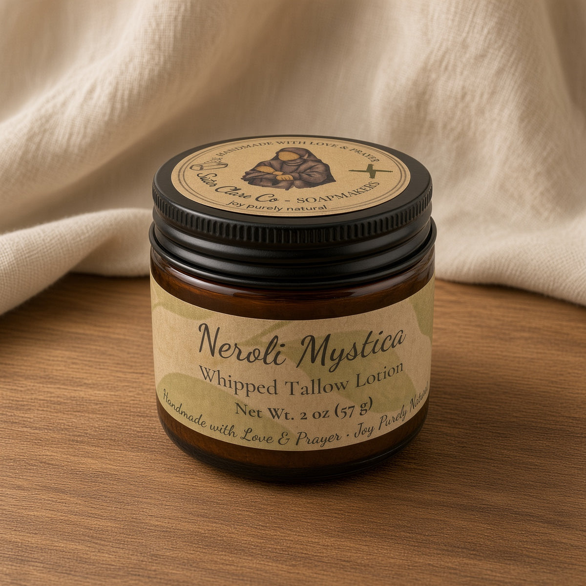 Neroli Mystica 2 oz lotion jar closed on wood