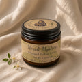 Neroli Mystica whipped tallow lotion jar on linen with blossom, three-quarter light